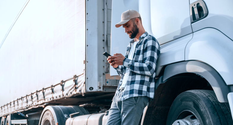 leaning-by-vehicle-using-phone-young-truck-driver-is-daytime