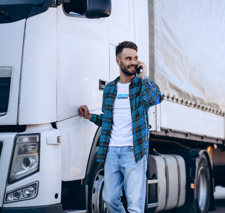 man-trucker-talking-phone-by-his-white-truck