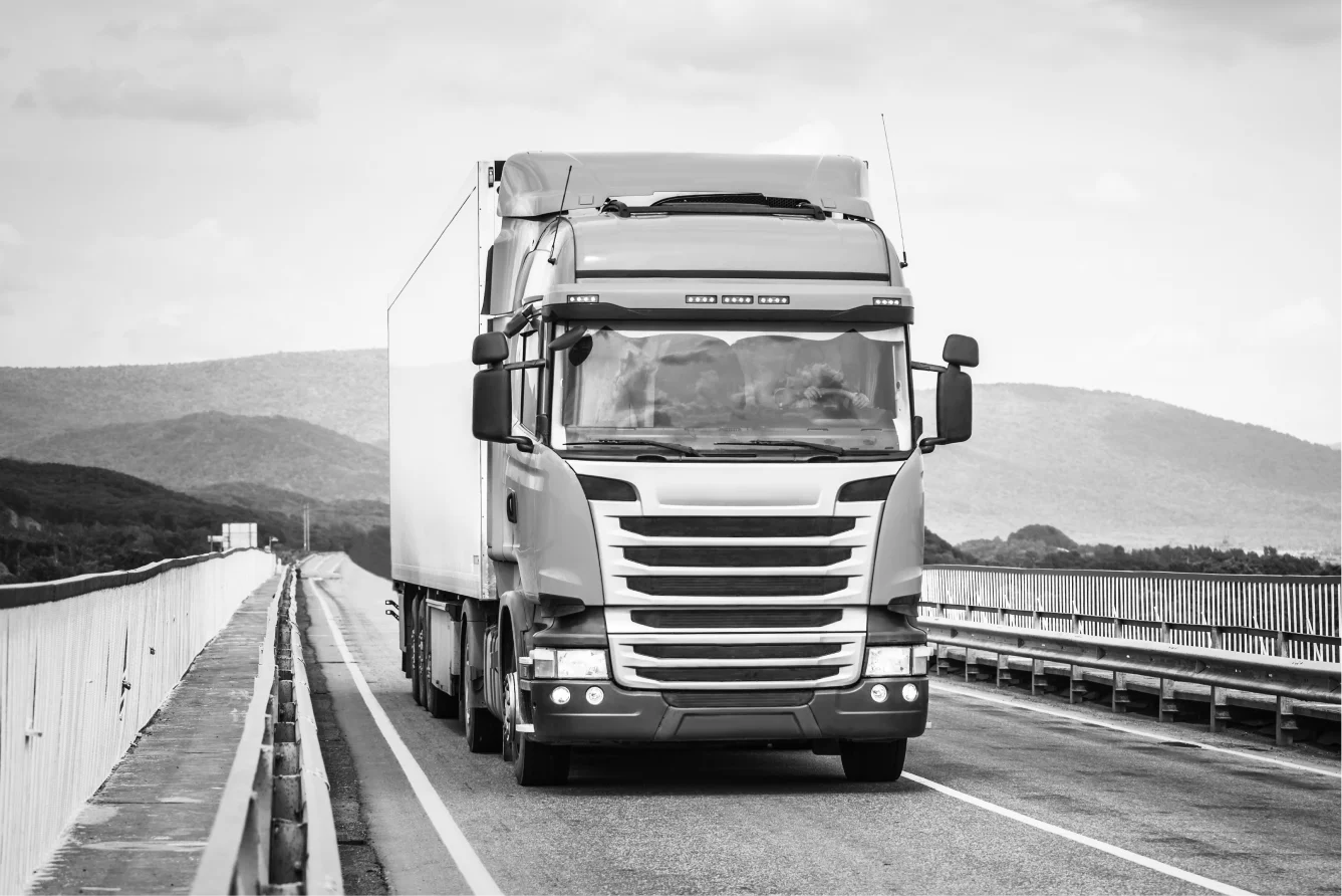 orange-truck-road-moving-by-bridge